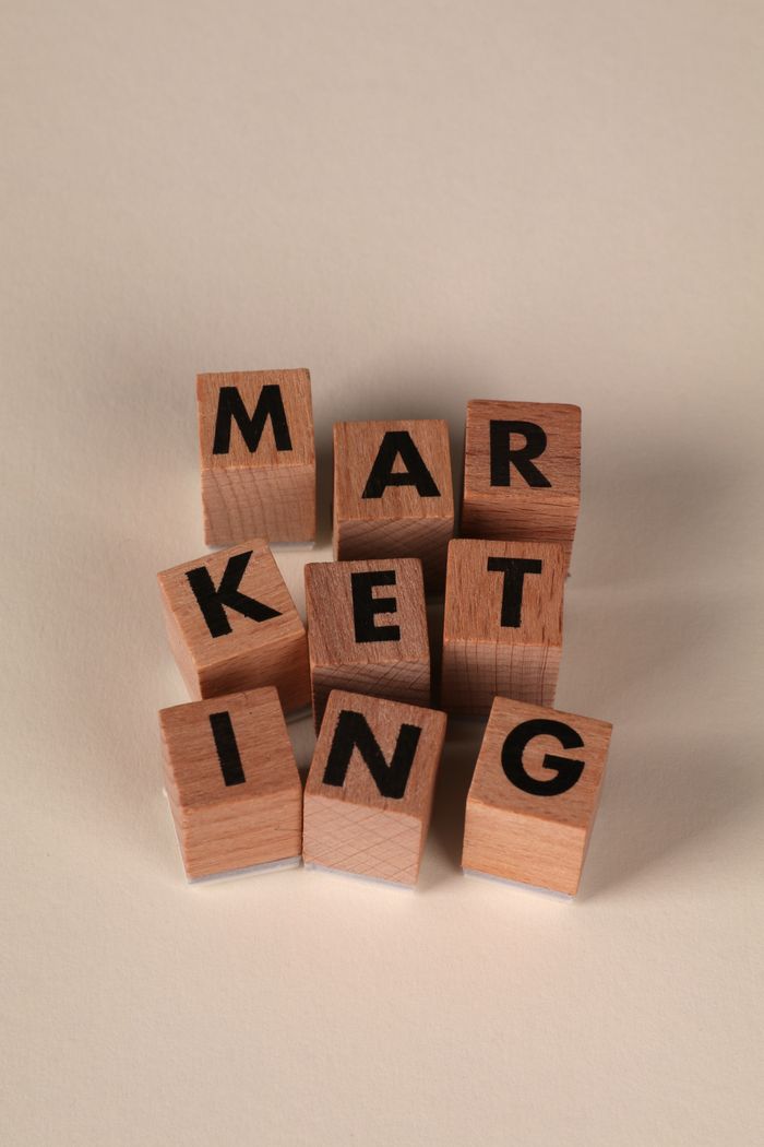 services-03 Wooden blocks arranged to spell 'MARKETING' on a neutral background.
