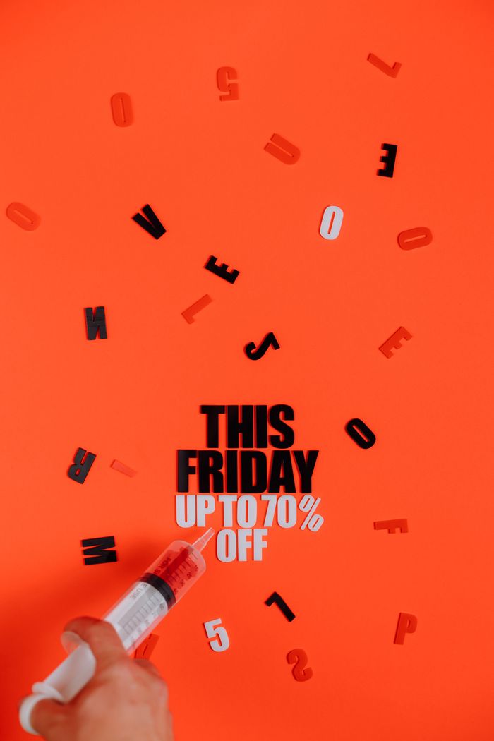 about-03 Vibrant Black Friday sale concept featuring a syringe and bold typography on red background.