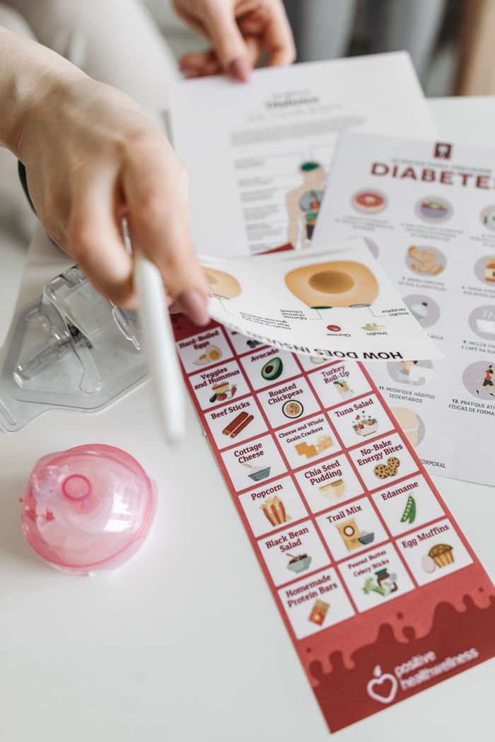 our-story-01 Informative diabetes pamphlets and dietary guide with hand interaction.