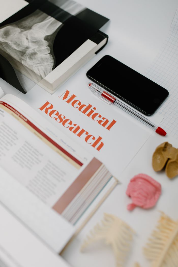 Mastering the First Impression: Your intriguing post title goes here Flat lay of medical research materials with books and anatomical models.